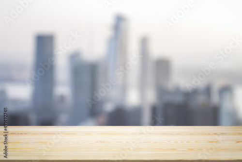 Blank table top made of wooden planks with beautiful blurry cityscape at daytime on background  mockup