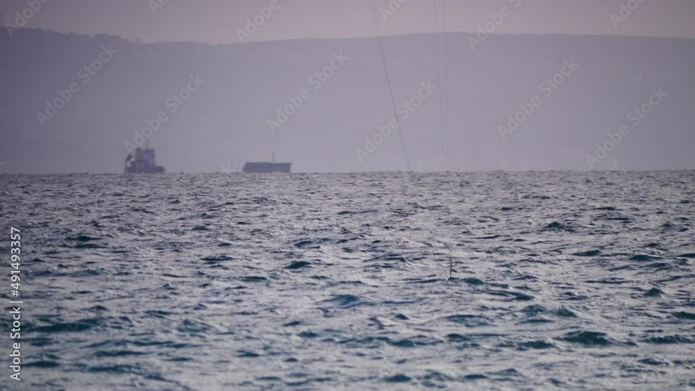 Kiteboarding sport. Kite surfer riding waves, falls and plunges into water. Recreational activity, water sports, action, hobby and fun. Slow motion Kiteboarding sport. Kite surfer riding waves, falls and plunges into water. Recreational activity, water sports, action, hobby and fun. Slow motion