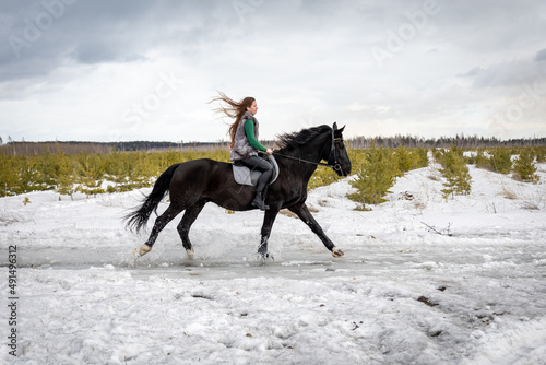 girl rides a horse. Walk with a horse through the countryside. fast jump © Galina