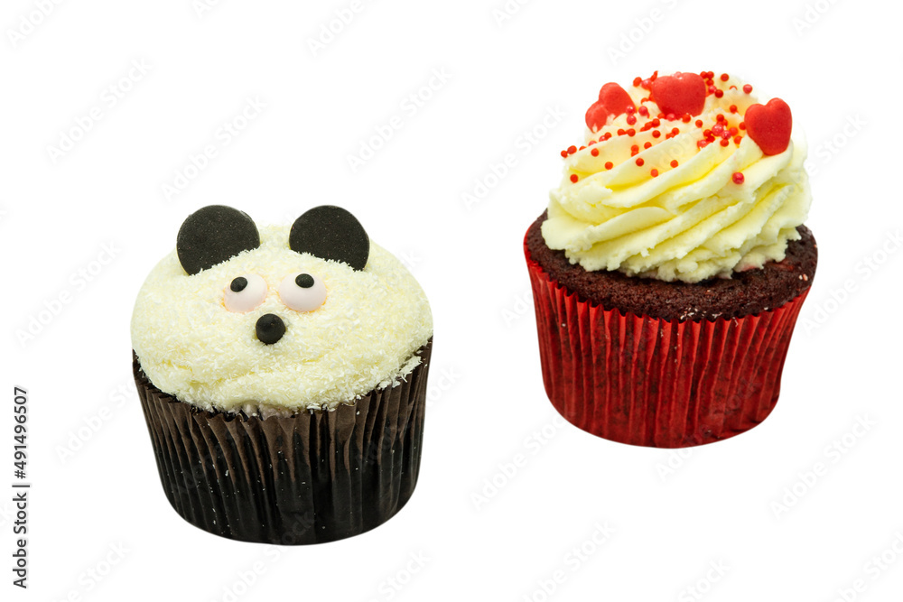 Two chocolate cupcakes with panda face cream shape and heart decoration on white background with copyspace Two chocolate cupcakes with panda face cream shape and heart decoration on white background with copyspace