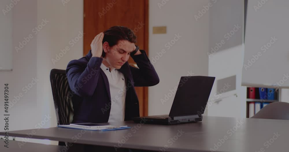 Exhausted businessman with laptop in office Exhausted businessman with laptop in office