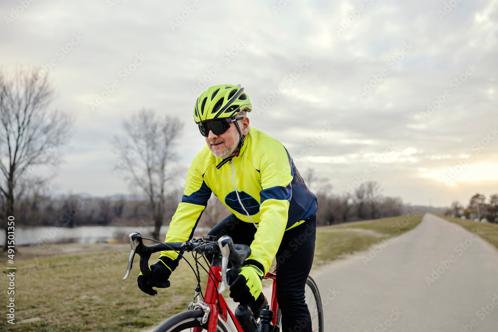 A fast bicycle rider cycling on path in nature. A fast bicycle rider cycling on path in nature.