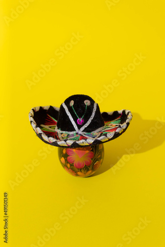 Easter mariachi egg with sombrero on top. Yellow background. 
