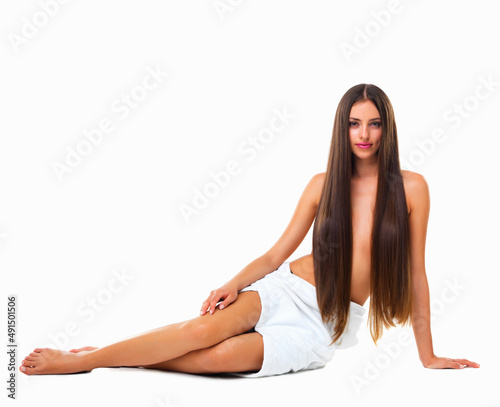 Like a modern day mermaid. Studio portrait of a young woman with long silky hair against a white background.