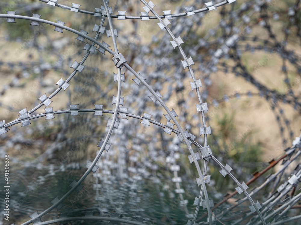 Illegal border with barbed wire crossing. The flow of refugees. Forced migration concept Illegal border with barbed wire crossing. The flow of refugees. Forced migration concept
