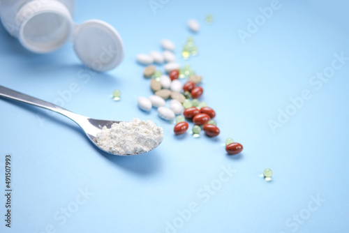 Nutritional supplements, vitamins and nutraceuticals on blue background. photo