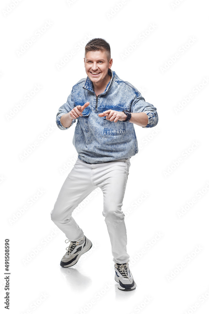 handsome young man in denim jacket with fist up handsome young man in denim jacket with fist up