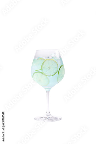 alcoholic drink blue lagoon with lime and ice stands on a white background
