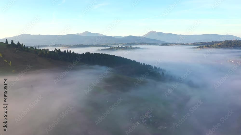 Tranquil rural landscape is covered with thick fog from a bird's eye view. Filmed in UHD 4k video. Tranquil rural landscape is covered with thick fog from a bird's eye view. Filmed in UHD 4k video.
