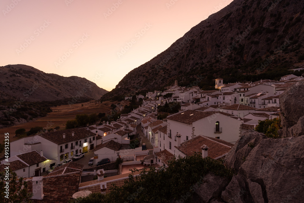 Panoramic view of the beautiful andalusian white town of Villaluenga del Rosario in Grazalema mountain range at sunset, Cadiz, Andalusia, Spain