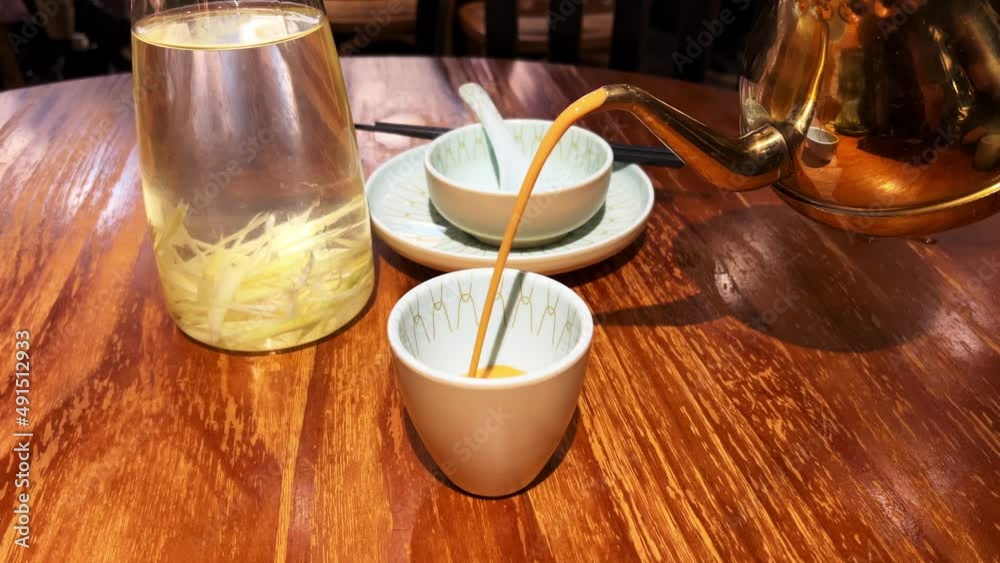 A man is eating thai food, pouring thai milk tea and serving pineapple fried rice A man is eating thai food, pouring thai milk tea and serving pineapple fried rice