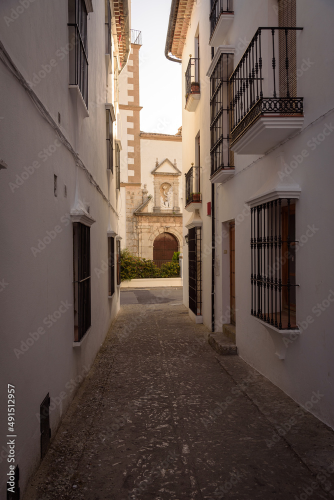 Street in the old town in the white village of Grazalema with the parish of the incarnation in the background, Natural Park of Grazalema mountain range, Cadiz, Andalusia, Spain