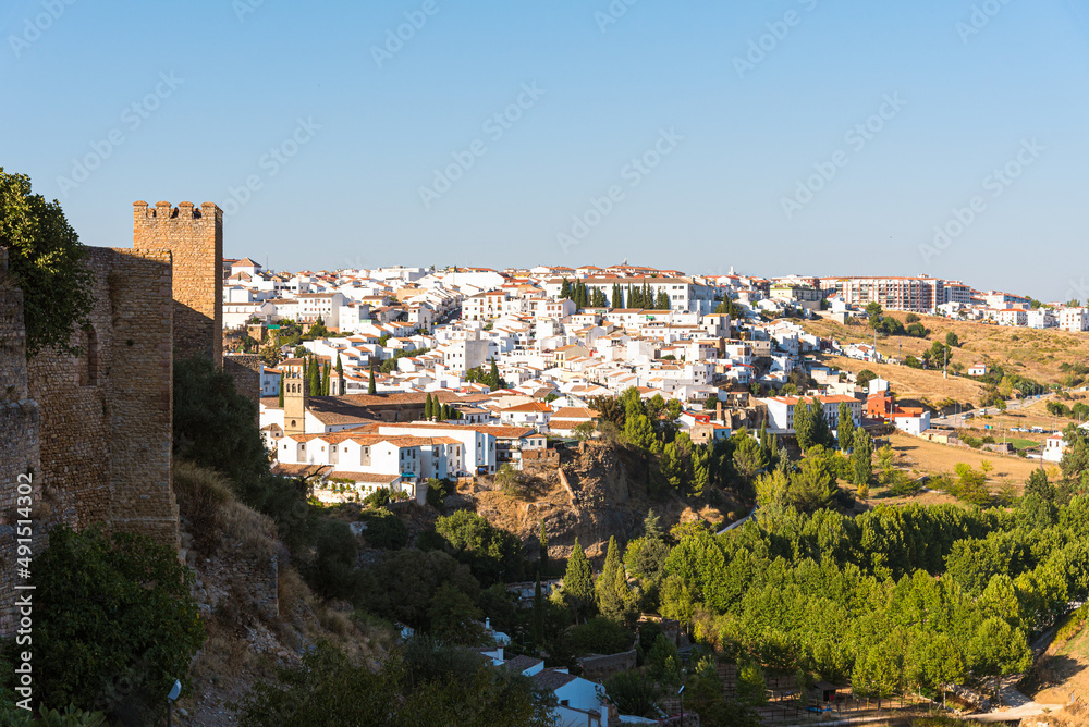 View of the famous white village of Ronda with the old wall in the foreground at daylight, Malaga province, Andalusia, Spain