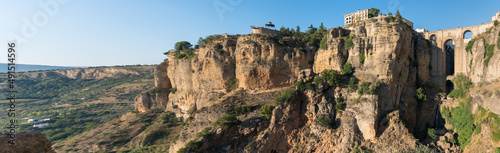 Panoramic view of Puente Nuevo (New bridge) over El Tajo gorge and the cliff in the famous white village of Ronda at daylight, Malaga province, Andalusia, Spain