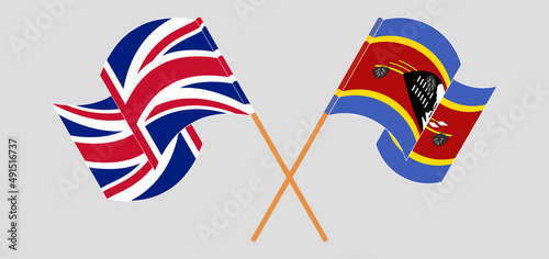 Crossed and waving flags of United Kingdom and Eswatini