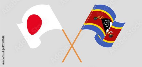 Crossed and waving flags of Japan and Eswatini