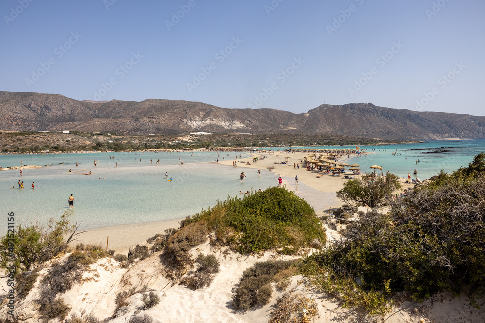  People relaxing on the famous pink coral beach of Elafonisi on Crete, Mediterannean sea, Greece