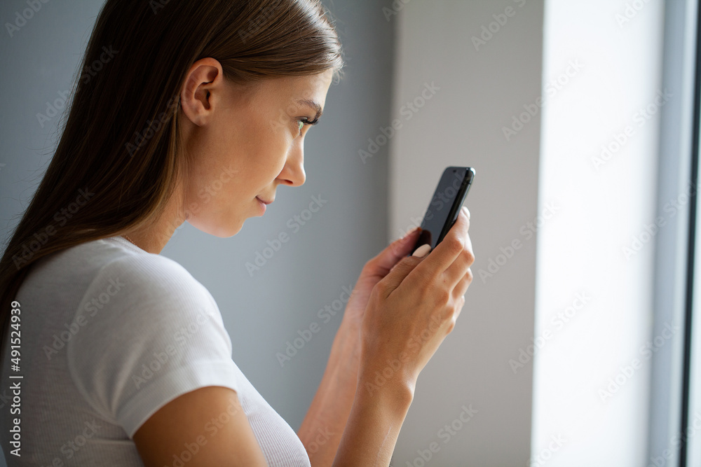 The young woman does not look away from the phone The young woman does not look away from the phone