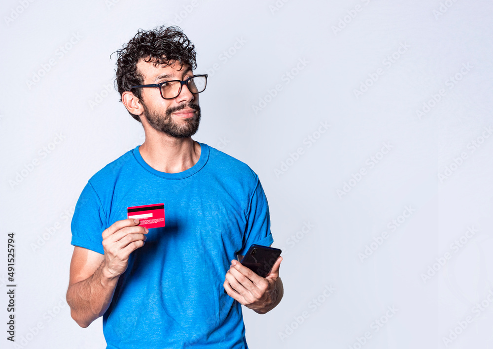 man with credit card and cell phone in hand, cheerful guy with cell phone and bank card, bank payment concept man with credit card and cell phone in hand, cheerful guy with cell phone and bank card, bank payment concept