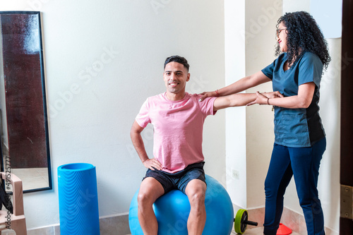 Professional physiotherapist working with female patient in rehabilitation center © Rand
