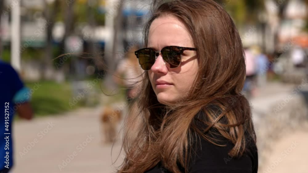 Young woman relaxes at the promenade of Miami Beach on a sunny day - travel photography Young woman relaxes at the promenade of Miami Beach on a sunny day - travel photography