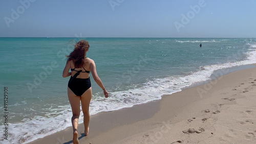 Running across a beach with blue ocean water - Miami Beach - travel photography