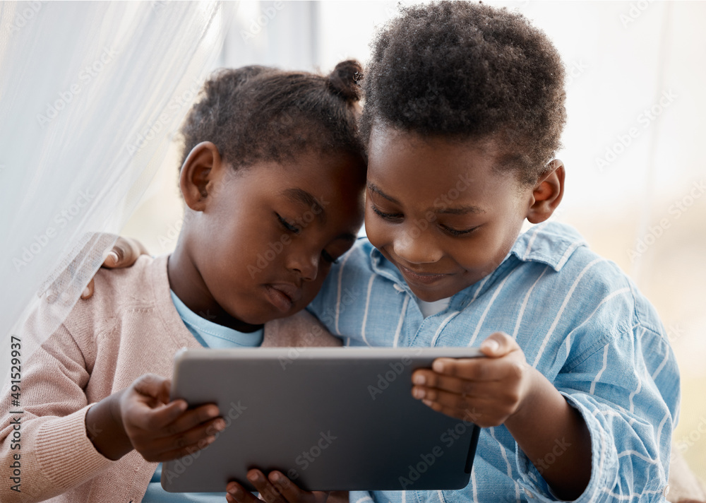 Screen time is meant to be shared. Shot of a little boy and girl watching something together on a digital tablet. Screen time is meant to be shared. Shot of a little boy and girl watching something together on a digital tablet.
