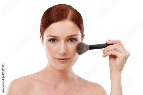 Make up is my art. Beauty shot of a young woman holding a makeup brush against a white background.