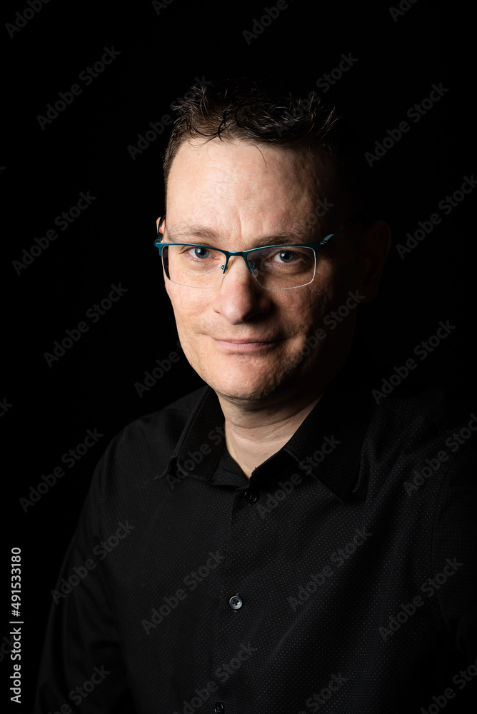 Obraz premium Portrait of a 42 year old business man, wearing a black shirt