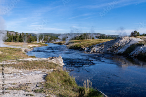 Geysers and thermal features steam along the banks of the Yellowstone River
