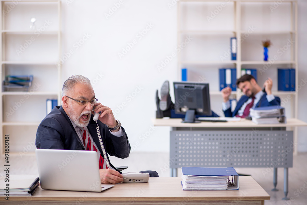 Two male colleagues working in the office Two male colleagues working in the office