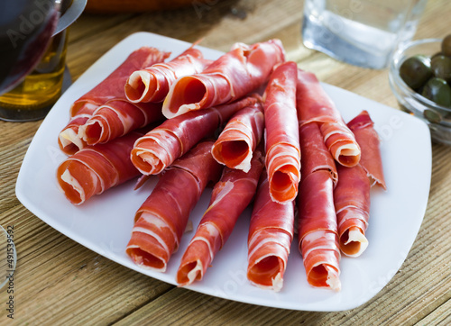 Traditional Spanish dish - jamon served in form of tubes on platter