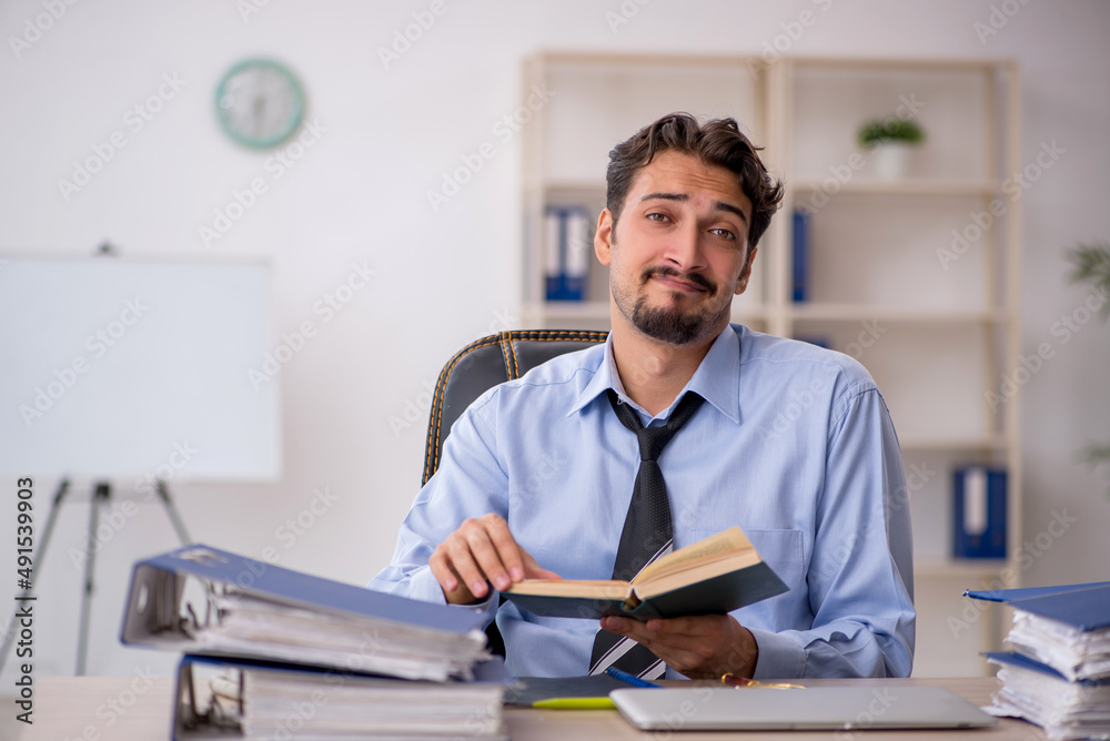 Young male employee working in the office Young male employee working in the office