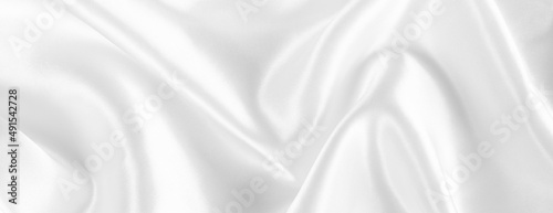 Abstract white silk fabric texture background. Creases of satin photo