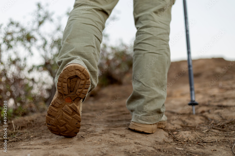Man walking with hiker shoes on nature ground trail