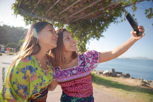 two women guna taking a selfie on the coast near the sea photo