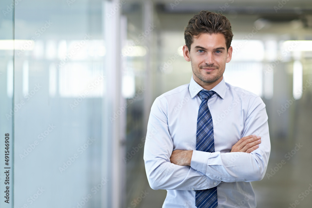 Hes a mover and shaker. Shot of a young businessman in a corporate office. Hes a mover and shaker. Shot of a young businessman in a corporate office.