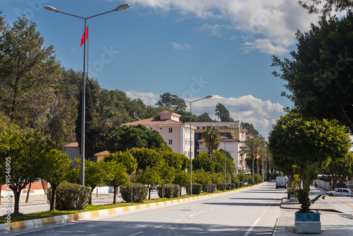 Colorful Turkish streets with low houses, the national Turkish flag flutters in the background