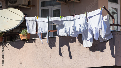 A stone  house in an turkish  city, laundry is drying on a rope photo