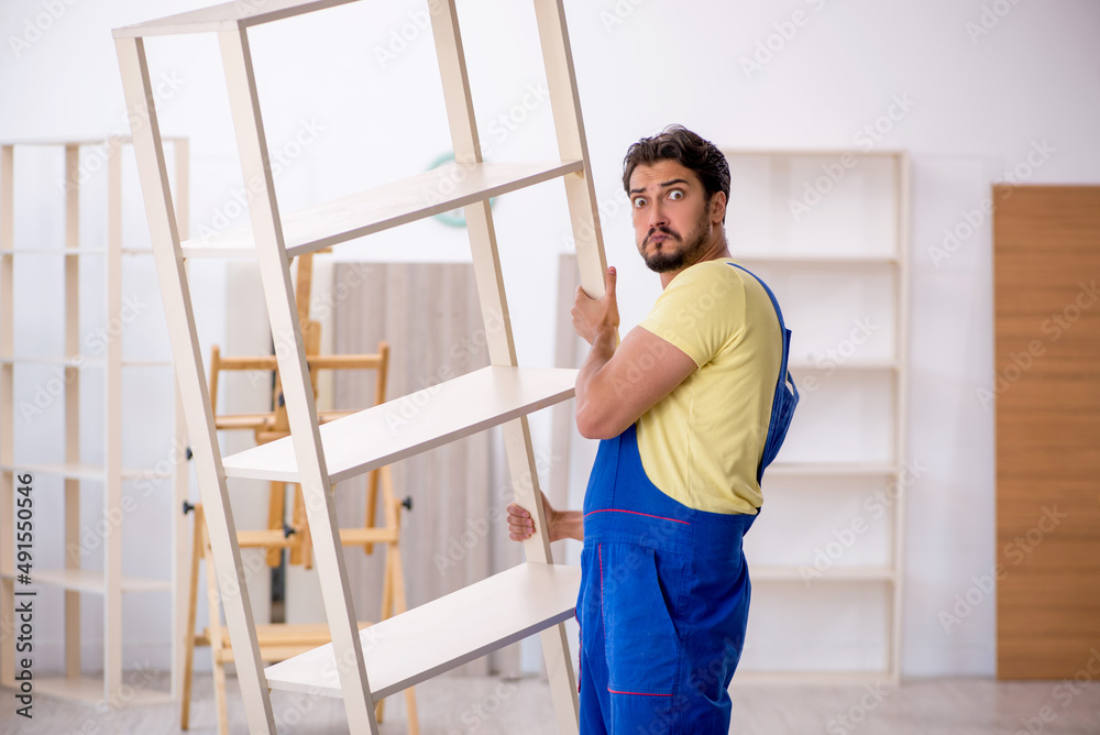 Young male carpenter working at home