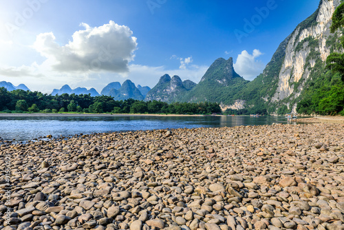 Beautiful mountains and pebble beach with river in Guilin, China.
