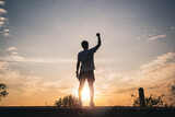 Confident men raise their hands in the air for success, victory and power. Sport man rise hand up on sunset sky background. Freedom and sport concept.