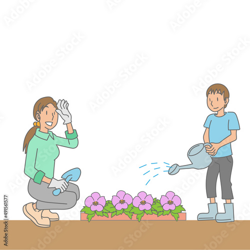 花壇に花を植える母親と子供