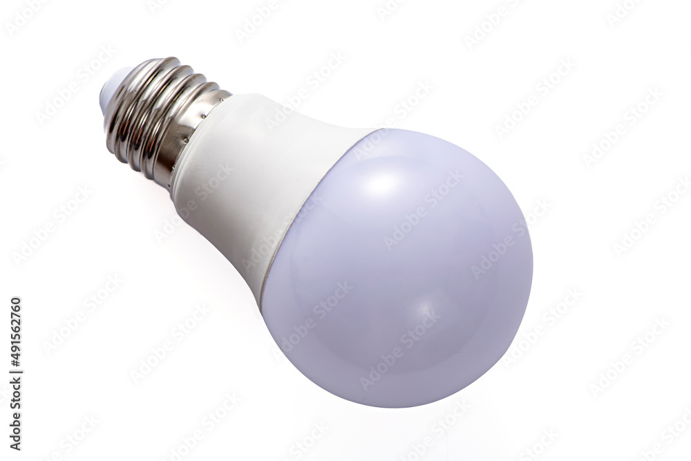 A white LED lamp with an E27 base lies on a white insulated background A white LED lamp with an E27 base lies on a white insulated background