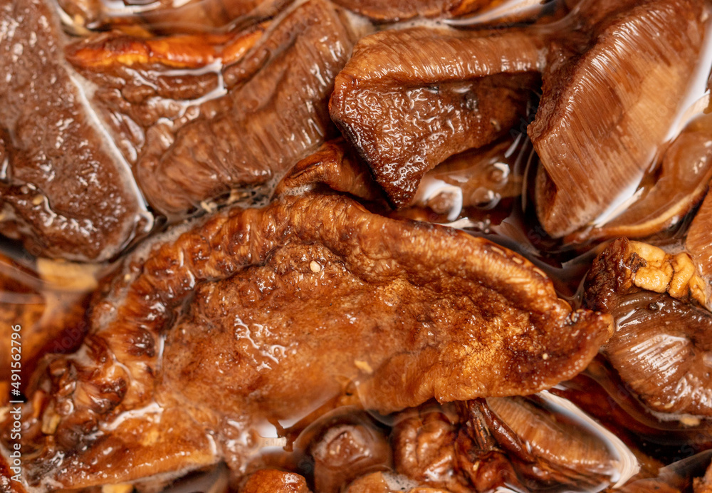 Dried mushrooms in water as background. Dried mushrooms in water as background.