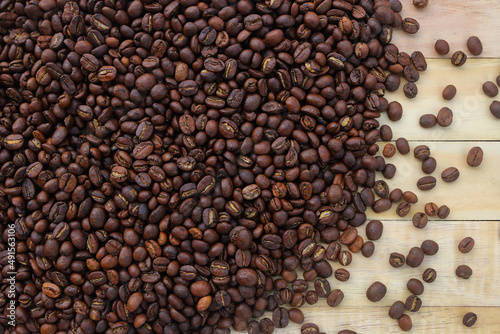 dark brown roast coffee beans on wooden board