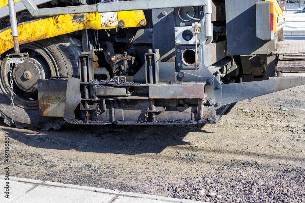 Image of an asphalt finisher preparing a sidewalk