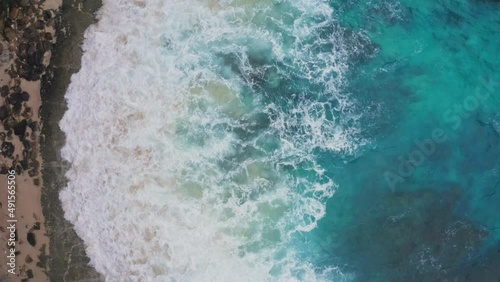 4K Aerial video of  blue waves in the ocean beach. 