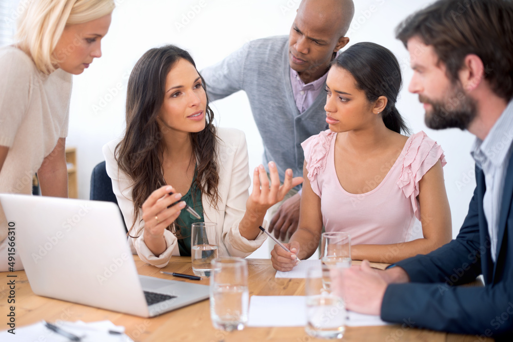 Working together. Shot of a group of business people in the middle of a discussion. Working together. Shot of a group of business people in the middle of a discussion.