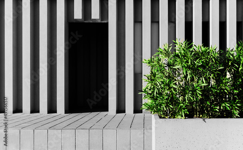 The contradiction of modern rhythm and living green nature. Facade of a building with a door and green plants in an abstract background. Rome designs on a sunny day.